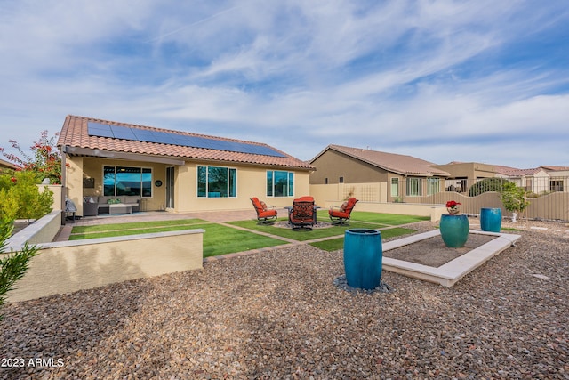 back of house featuring solar panels and a patio