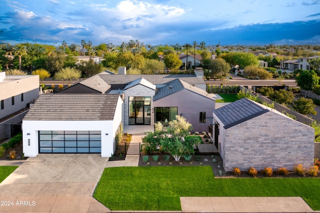 view of front of home featuring a garage and a front lawn