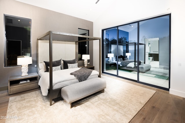 bedroom featuring vaulted ceiling and hardwood / wood-style flooring