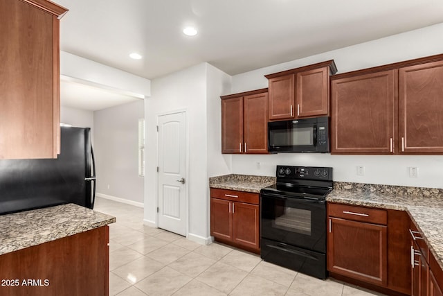 kitchen featuring light stone counters, black appliances, and light tile patterned flooring