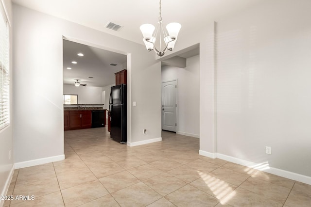 unfurnished dining area featuring a chandelier and light tile patterned flooring