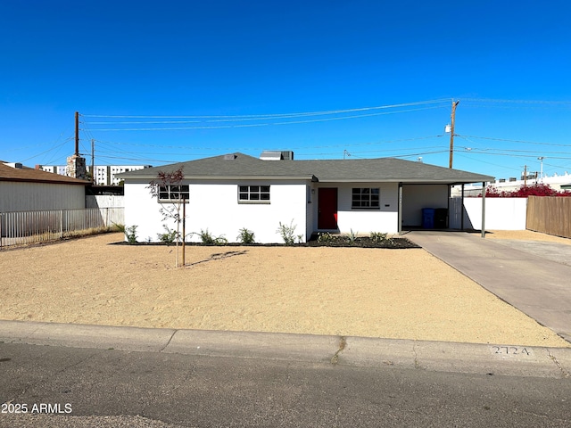 ranch-style home featuring a carport