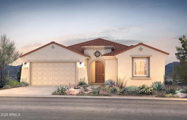 mediterranean / spanish-style house with driveway, an attached garage, and stucco siding