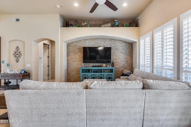 living area featuring visible vents, a ceiling fan, and recessed lighting