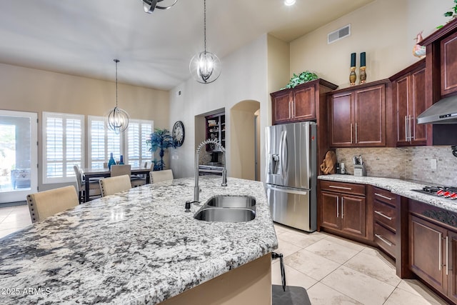 kitchen with visible vents, tasteful backsplash, light tile patterned floors, a sink, and stainless steel appliances