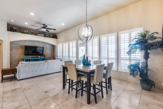 dining space featuring ceiling fan with notable chandelier, recessed lighting, light tile patterned flooring, and a wealth of natural light