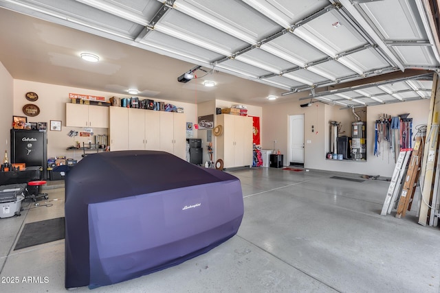 garage with water heater and a garage door opener
