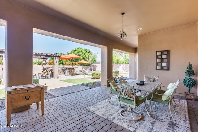 view of patio / terrace with fence, a pergola, and outdoor dining area