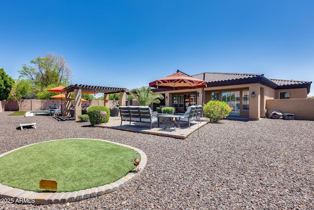 rear view of property with a pergola, a patio, a fenced backyard, stucco siding, and a tiled roof