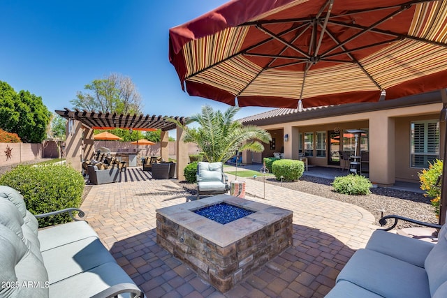view of patio with an outdoor living space with a fire pit, fence, and a pergola