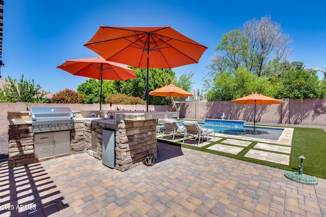 view of patio featuring a fenced in pool, a fenced backyard, a grill, and area for grilling