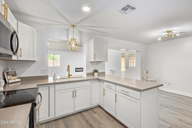 kitchen with hanging light fixtures, light hardwood / wood-style floors, kitchen peninsula, and white cabinetry