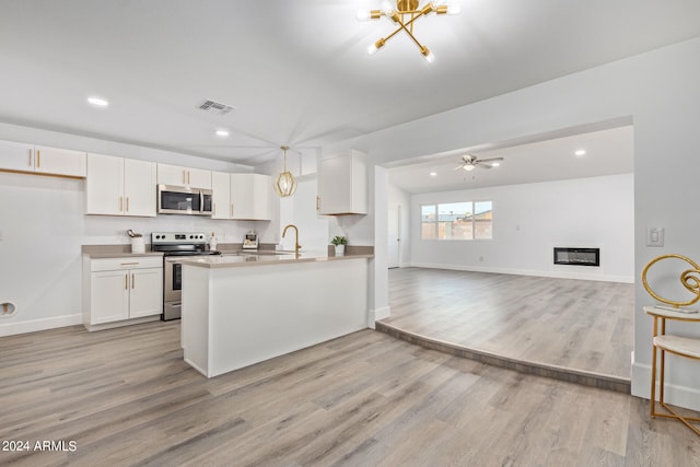 kitchen featuring white cabinets, light hardwood / wood-style flooring, ceiling fan with notable chandelier, and electric range oven