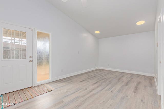 entryway featuring lofted ceiling, a wealth of natural light, and light hardwood / wood-style floors