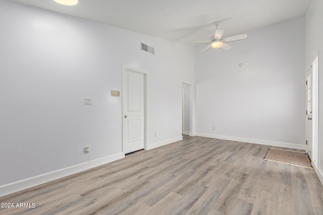 empty room with ceiling fan and light wood-type flooring