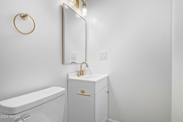 bathroom featuring toilet and vanity