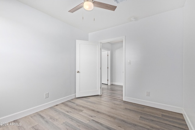 unfurnished room featuring hardwood / wood-style floors and ceiling fan