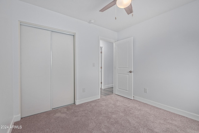 unfurnished bedroom featuring a closet, ceiling fan, and carpet flooring