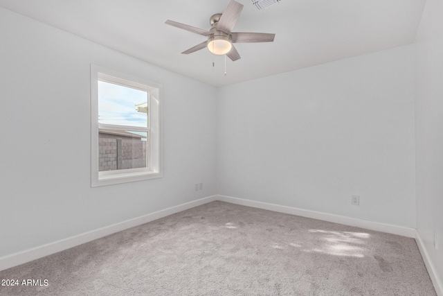 empty room with ceiling fan and carpet flooring