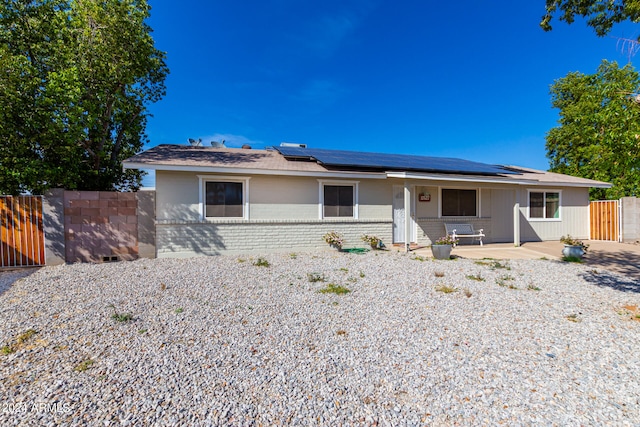 ranch-style house with solar panels