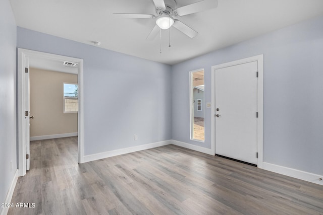 empty room with hardwood / wood-style floors and ceiling fan