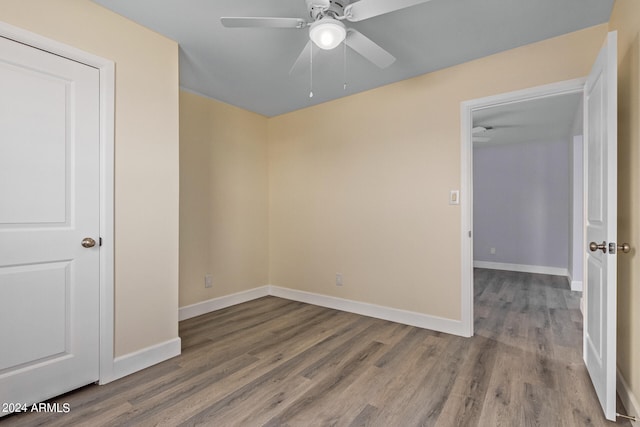 empty room featuring hardwood / wood-style flooring and ceiling fan