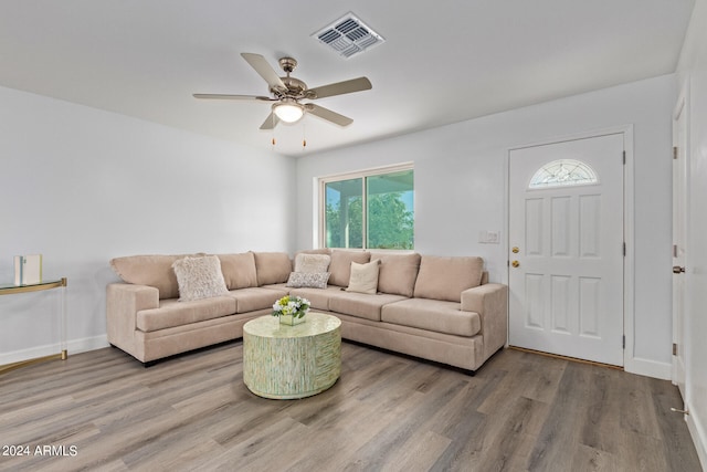 living room featuring wood-type flooring and ceiling fan