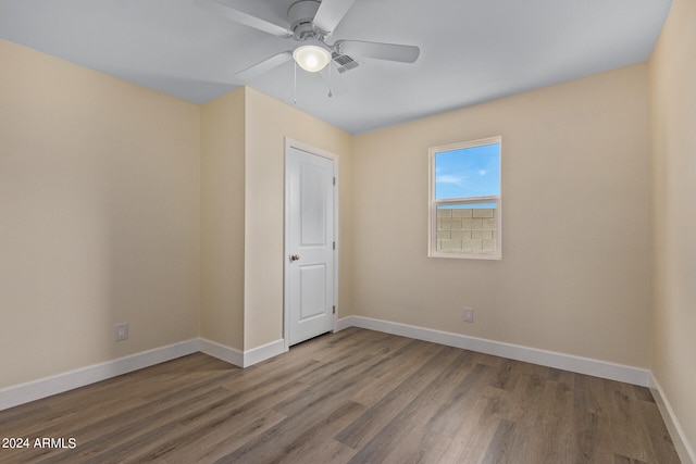 spare room featuring wood-type flooring and ceiling fan