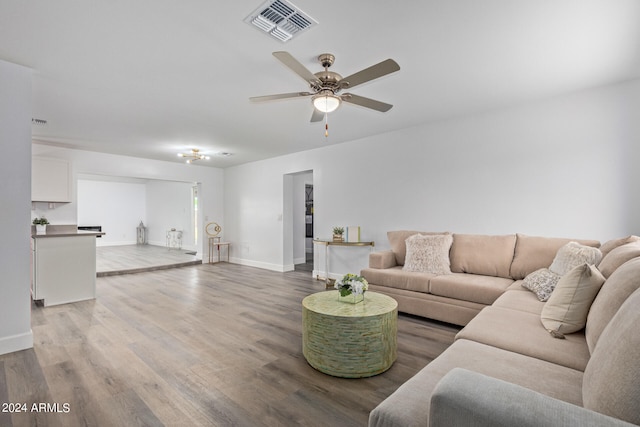 living room featuring ceiling fan and hardwood / wood-style flooring