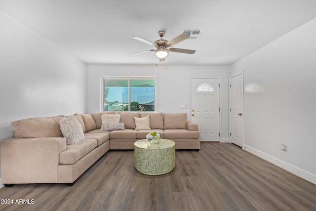 living room featuring wood-type flooring and ceiling fan