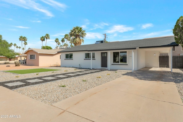 1205 W 7th St, Tempe, AZ 85281 - ranch-style house with driveway, a carport, stucco siding, and a shingled roof