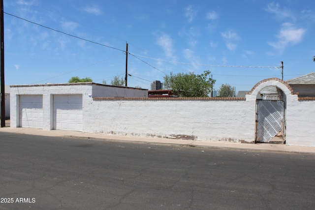 exterior space featuring fence and a detached garage