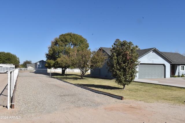 view of front of house with a garage and a front lawn