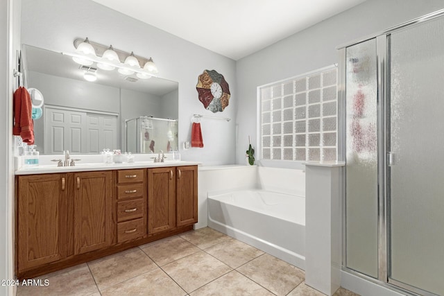 bathroom with tile patterned floors, vanity, and plus walk in shower