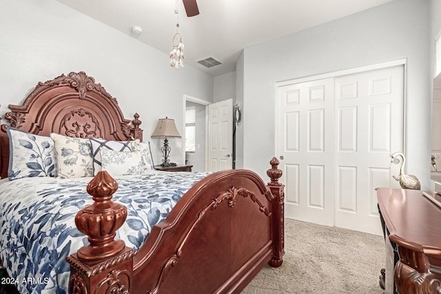 carpeted bedroom with ceiling fan and a closet