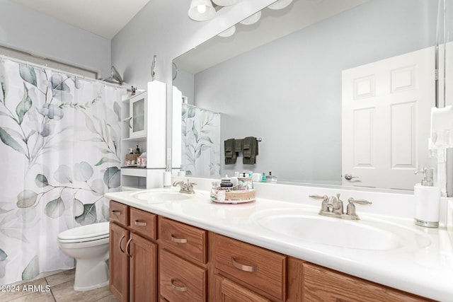 bathroom featuring tile patterned flooring, vanity, toilet, and curtained shower