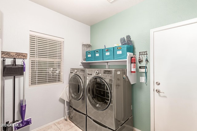 washroom with washer and clothes dryer and light tile patterned flooring