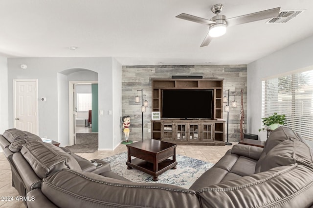 living room featuring ceiling fan and light tile patterned floors