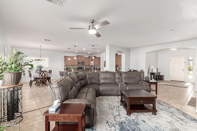 tiled living room with ceiling fan