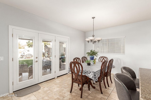 dining area with french doors, light tile patterned flooring, and a chandelier