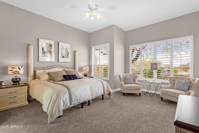 carpeted bedroom featuring a ceiling fan, multiple windows, and baseboards