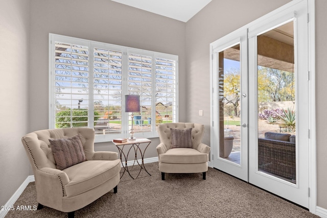 sitting room featuring carpet flooring, a wealth of natural light, and baseboards