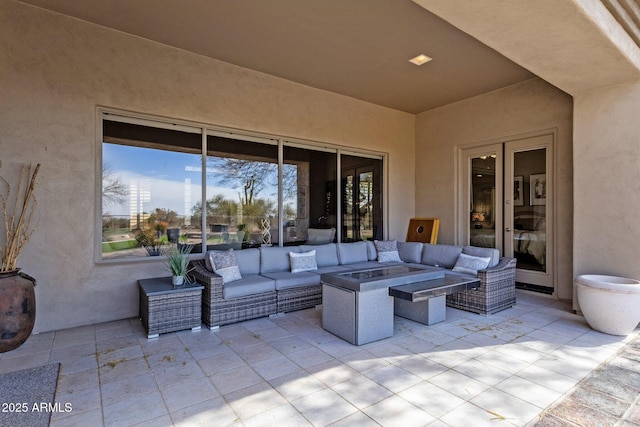 view of patio featuring an outdoor living space with a fire pit