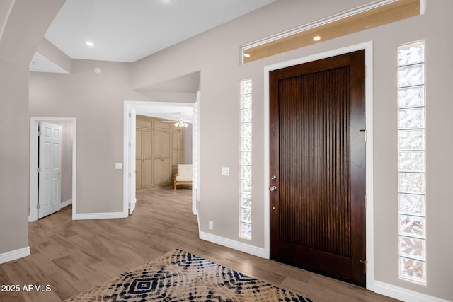 foyer featuring recessed lighting, wood finished floors, and baseboards