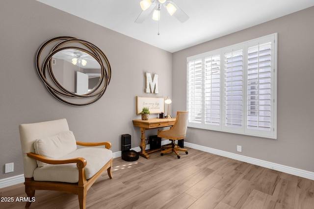 office featuring wood finished floors, a ceiling fan, and baseboards