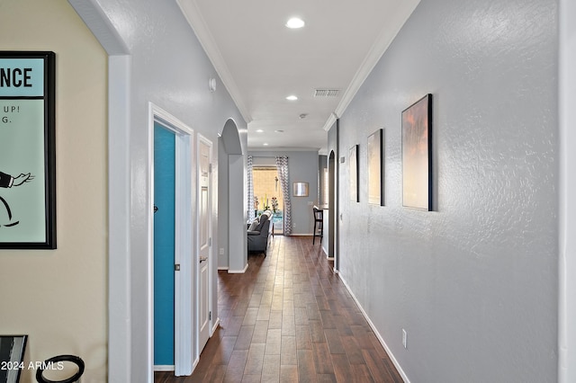 hallway with dark hardwood / wood-style floors and ornamental molding