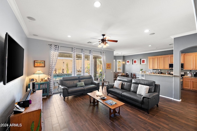 living room featuring ceiling fan, dark hardwood / wood-style floors, and ornamental molding