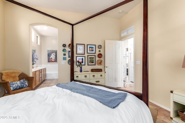 1851 W Periwinkle Way, Chandler, AZ 85248 - bedroom with arched walkways, light tile patterned floors, and connected bathroom
