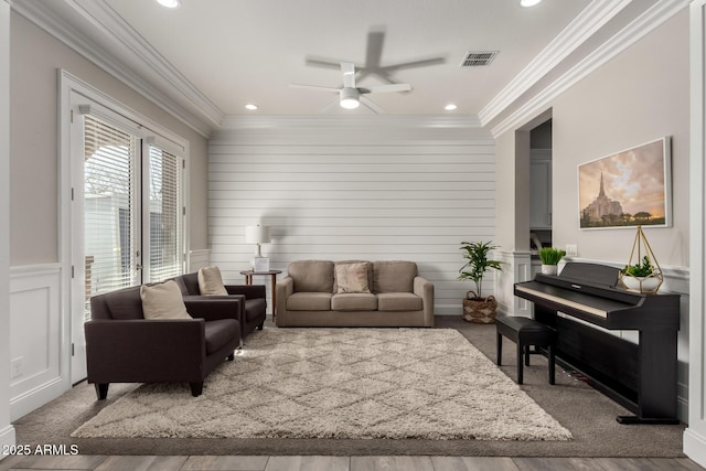 living room with ceiling fan, hardwood / wood-style floors, and ornamental molding