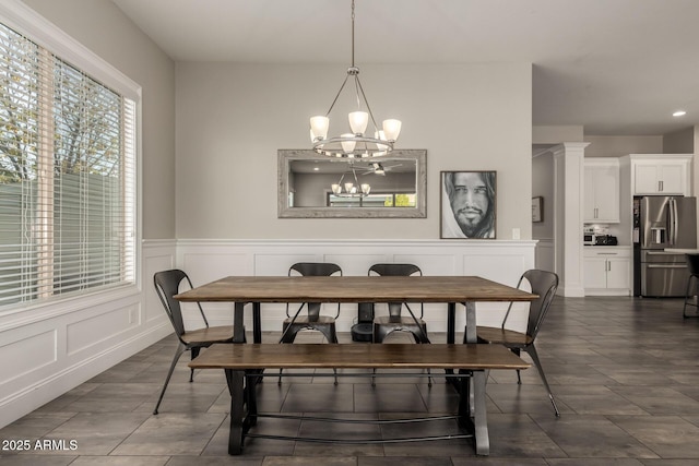 dining space with an inviting chandelier